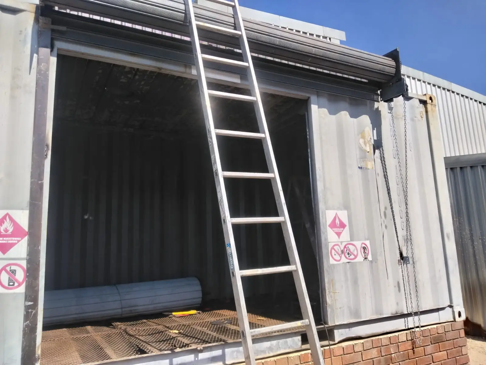 Chain-operated roller shutter door undergoing mechanical repair