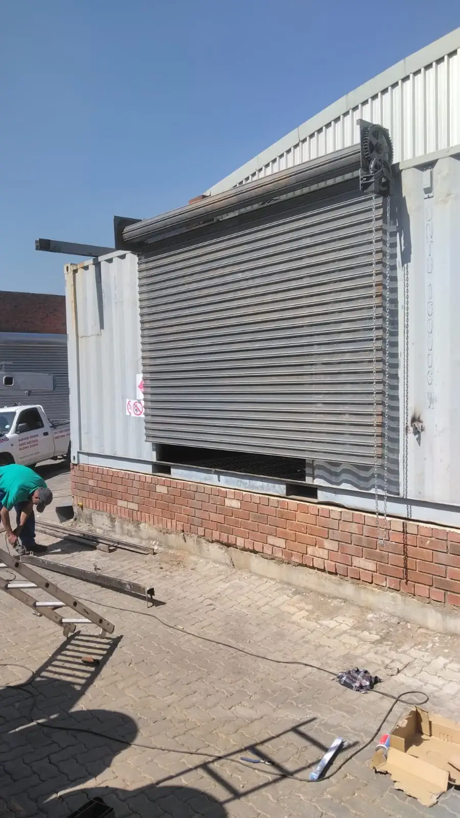 Technician working on an industrial roller shutter door