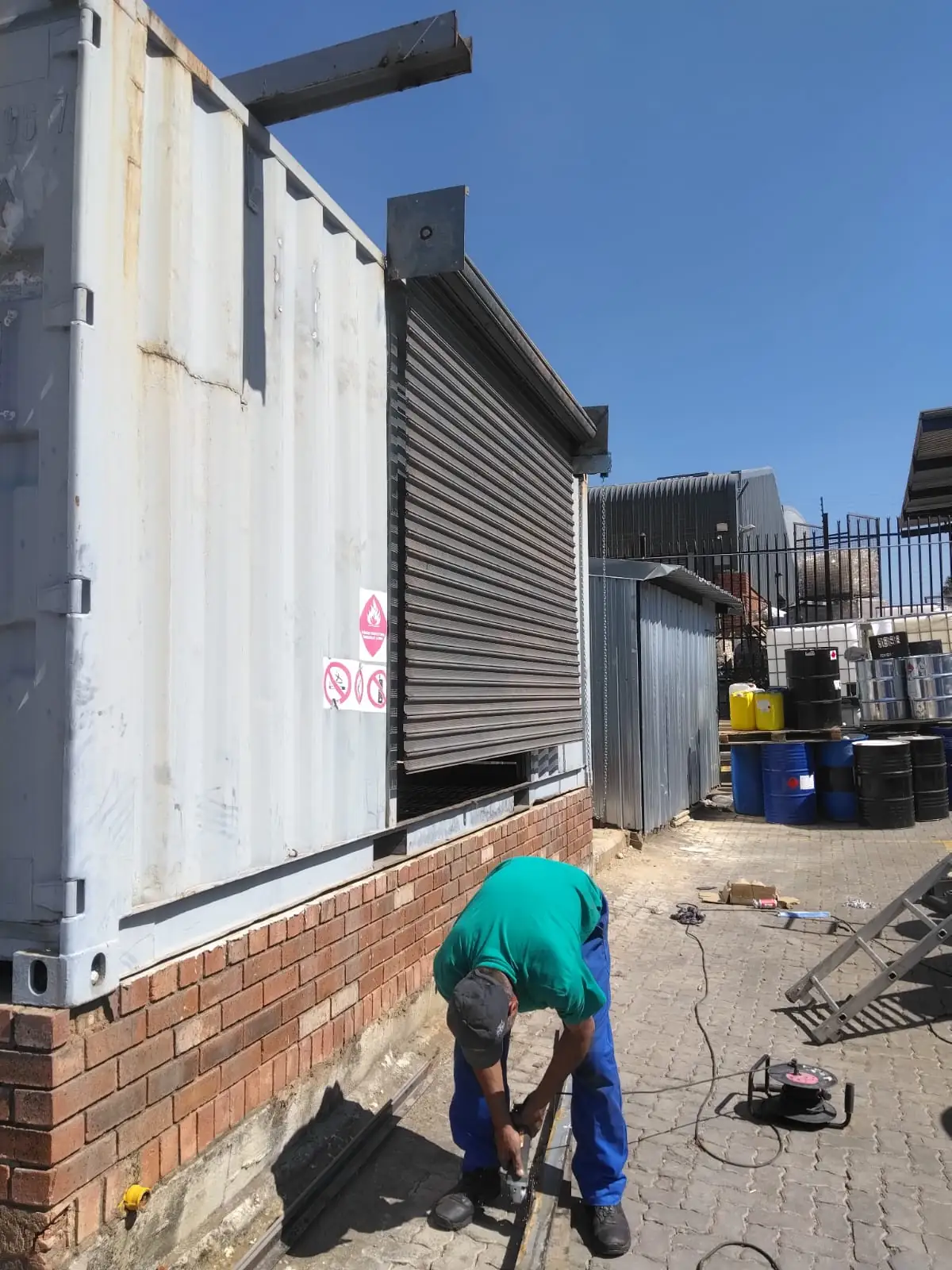 Roller shutter door lifting mechanism repair in progress